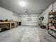 Spacious garage featuring concrete floors and white walls, along with ample space for storage at 2241 Mystic Maze Ln, Minneola, FL 34715