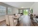 Living room and dining area combination featuring natural light, wood-look floors and contemporary furnishings at 2241 Mystic Maze Ln, Minneola, FL 34715