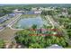 Aerial view shows home's proximity to community pond, surrounding greenery, and nearby amenities at 2415 S Oak Ave, Sanford, FL 32771