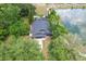 Aerial view of a beautiful landscaped property with backyard pool, adjacent to a tranquil lake at 2415 S Oak Ave, Sanford, FL 32771