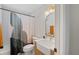 Modern bathroom featuring a sleek vanity, farmhouse sink, and a stylish shower curtain at 2415 S Oak Ave, Sanford, FL 32771