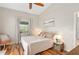 Cozy bedroom with hardwood floors, a ceiling fan, and serene decor at 2415 S Oak Ave, Sanford, FL 32771