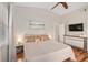Comfortable bedroom features hardwood floors, a ceiling fan, and neutral colors at 2415 S Oak Ave, Sanford, FL 32771