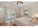 Light bedroom features hardwood floors and French doors that lead to a beautiful pool at 2415 S Oak Ave, Sanford, FL 32771