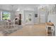 Light and airy dining room showcasing a stylish chandelier, a decorative hutch, and French doors to the lanai at 2415 S Oak Ave, Sanford, FL 32771