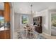 Inviting dining area featuring a wooden table set, elegant chandelier, and a view of the serene lake at 2415 S Oak Ave, Sanford, FL 32771
