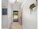 Bright foyer with tile flooring, decorative light fixture, and an open view to the backyard patio at 2415 S Oak Ave, Sanford, FL 32771