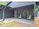 Inviting front porch with seating, ceiling fan, and stylish arched window, perfect for relaxing outdoors at 2415 S Oak Ave, Sanford, FL 32771