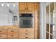 Modern kitchen boasts stainless steel oven, granite countertops, and sleek wooden cabinetry at 2415 S Oak Ave, Sanford, FL 32771
