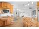 Open-concept kitchen features wood cabinetry, granite countertops, and a seamless flow into the living spaces at 2415 S Oak Ave, Sanford, FL 32771