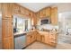 Bright kitchen features wood cabinets, granite countertops, stainless steel appliances, and a garden window at 2415 S Oak Ave, Sanford, FL 32771