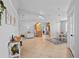 Bright living room features neutral tones, tile floors, and an open layout to the kitchen and dining areas at 2415 S Oak Ave, Sanford, FL 32771