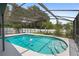 Enjoy Florida living with this screened-in pool featuring a shallow sun shelf and clear blue water at 2415 S Oak Ave, Sanford, FL 32771