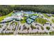 Breathtaking aerial view of the community's amenities, including pool, tennis courts, and lush landscaping at 2458 Cliff Way, St Cloud, FL 34771