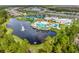 Expansive community with pools, tennis courts, and scenic lake views from a beautiful aerial perspective at 2458 Cliff Way, St Cloud, FL 34771