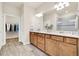 Bathroom featuring a double sink vanity, walk-in shower, and a walk-in closet with ample storage at 2458 Cliff Way, St Cloud, FL 34771