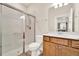 Bathroom featuring a glass-enclosed shower, wood vanity with white countertop, toilet, and wood-look flooring at 2458 Cliff Way, St Cloud, FL 34771