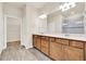 Bathroom with double vanity sinks, tile floors, and a separate room for the toilet at 2458 Cliff Way, St Cloud, FL 34771