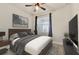 Inviting bedroom with a dark wood bed frame, ceiling fan, and a large window providing natural light at 2458 Cliff Way, St Cloud, FL 34771