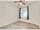 Bright bedroom featuring wood-look flooring, a ceiling fan, and a window with stylish dark curtains at 2458 Cliff Way, St Cloud, FL 34771