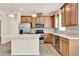 Bright kitchen featuring stainless steel appliances, stylish backsplash, and an island at 2458 Cliff Way, St Cloud, FL 34771