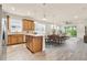 Open-concept kitchen with a central island, wood cabinets, and modern lighting fixtures over the dining area at 2458 Cliff Way, St Cloud, FL 34771
