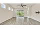Spacious living room with wood-style floors and a sliding glass door to the outside at 2458 Cliff Way, St Cloud, FL 34771