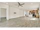 Open living space with wood floors, recessed lighting, and a view into the modern kitchen at 2458 Cliff Way, St Cloud, FL 34771