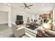 Spacious living room with an open layout, modern furniture, and views into the kitchen and dining area at 2458 Cliff Way, St Cloud, FL 34771