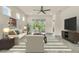 Bright living room featuring neutral furniture, a ceiling fan, and sliding glass doors that lead to the patio at 2458 Cliff Way, St Cloud, FL 34771