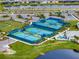 Aerial view of the community tennis and pickleball courts with well-maintained landscaping and parking at 2458 Cliff Way, St Cloud, FL 34771