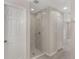 Updated bathroom showcasing a glass-enclosed shower with modern tile work at 2755 Abbey Ave, Orlando, FL 32833