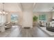 Bright foyer showcasing an open floor plan with elegant dining and living areas, enhancing the sense of space at 2755 Abbey Ave, Orlando, FL 32833
