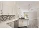 Well-lit kitchen featuring sleek white cabinetry, stainless steel appliances, and stylish backsplash at 2755 Abbey Ave, Orlando, FL 32833
