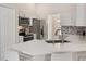 Modern kitchen features white cabinets, stainless steel appliances, and a breakfast bar for casual dining at 2755 Abbey Ave, Orlando, FL 32833
