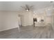 Bright, open-concept living area with wood floors that flows into a kitchen with bar seating at 2755 Abbey Ave, Orlando, FL 32833