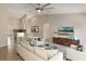 Bright living room with vaulted ceilings, ceiling fan, and an open layout connecting the kitchen and dining areas at 2755 Abbey Ave, Orlando, FL 32833
