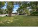 Expansive backyard with mature trees and a white picket fence offers plenty of space and privacy at 3049 Condel Drive, Orlando, FL 32812