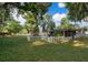 Lush backyard featuring a white picket fence and mature trees, perfect for outdoor enjoyment at 3049 Condel Drive, Orlando, FL 32812