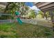 Inviting backyard featuring a play set, swing, and secure white picket fence for Gathering enjoyment at 3049 Condel Drive, Orlando, FL 32812