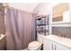 Bathroom with a shower featuring tiled walls, alongside a vanity and organized towel rack at 3049 Condel Drive, Orlando, FL 32812