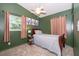 Cozy bedroom featuring a plush carpet, ceiling fan, and tasteful floral artwork at 3049 Condel Drive, Orlando, FL 32812