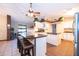 Bright, open kitchen with granite countertops, white cabinets, and island with seating at 3049 Condel Drive, Orlando, FL 32812