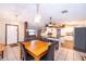 Open-concept kitchen and dining area with an island, modern appliances, and ample seating at 3049 Condel Drive, Orlando, FL 32812
