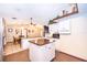 Bright kitchen features an island, white cabinetry, and tile floors that flow into an adjacent eating area at 3049 Condel Drive, Orlando, FL 32812