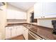Close up of the kitchen with stainless steel appliances, white cabinets, and a granite countertop at 3049 Condel Drive, Orlando, FL 32812