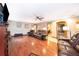 Inviting living room with wood floors, ceiling fan, fireplace and leather furniture at 3049 Condel Drive, Orlando, FL 32812