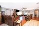 Expansive living room featuring a fireplace, wood floors, a ceiling fan, and leather sofas at 3049 Condel Drive, Orlando, FL 32812
