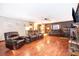 Open living room with wood floors, ceiling fan, a fireplace, and multiple leather reclining sofas at 3049 Condel Drive, Orlando, FL 32812