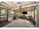 Relaxing screened porch with comfortable seating, ceiling fan, and outdoor views at 3049 Condel Drive, Orlando, FL 32812